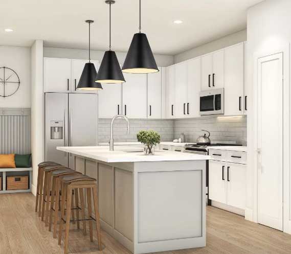 This image shows a modern kitchen interior with white cabinets, stainless steel appliances, a central island with bar stools, and black pendant lights.