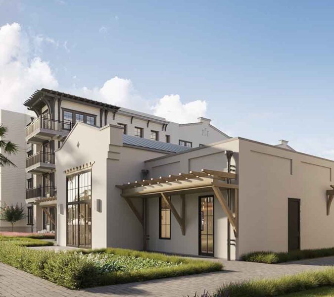 The image shows a modern residential building with beige walls, large windows, a flat roof, and a pergola over the entrance amidst landscaped greenery.