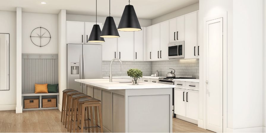 Modern kitchen interior with white cabinetry, stainless steel appliances, and a central island with bar stools. Black pendant lights hang above the island.