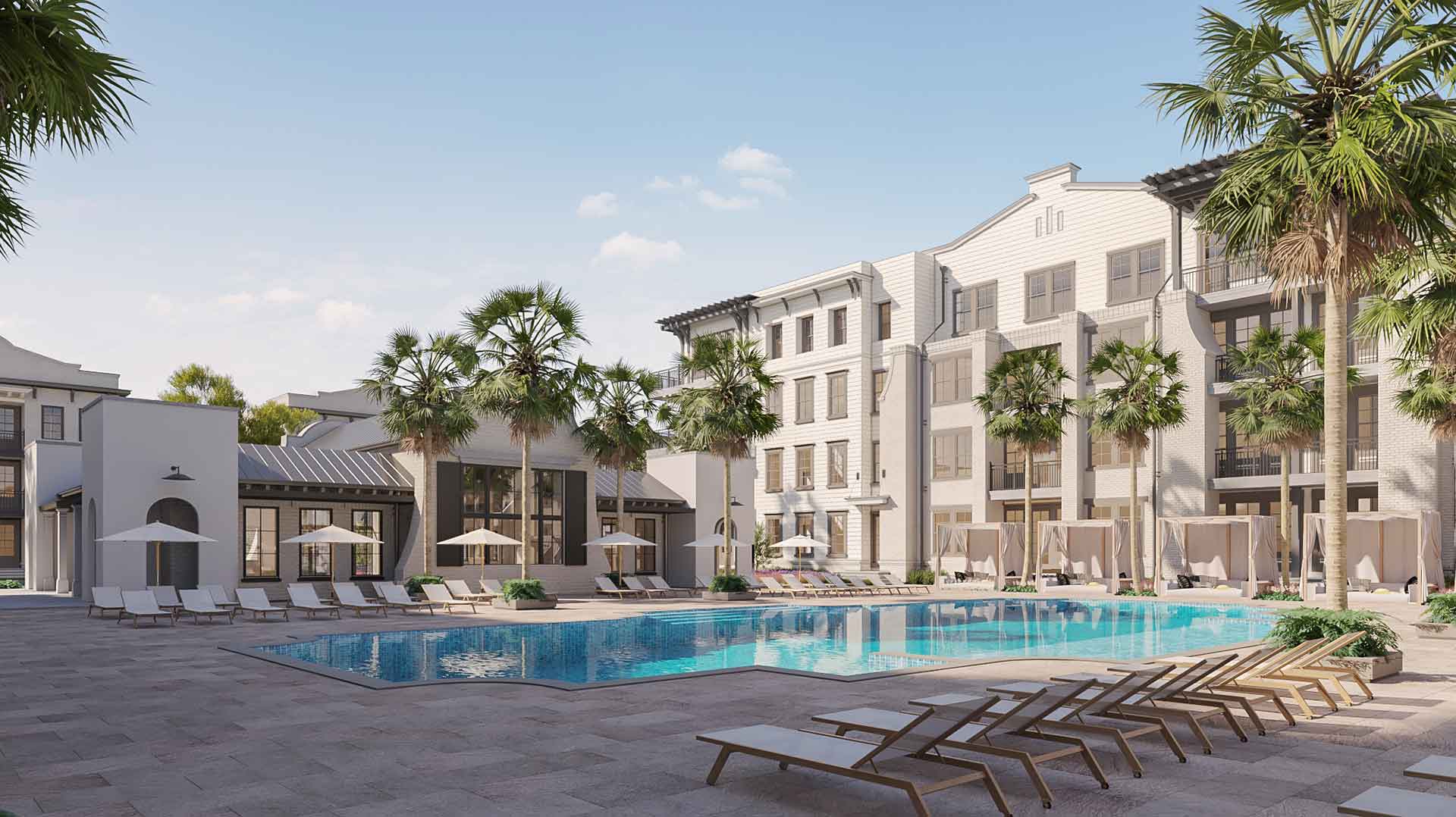 This image shows a sunny poolside with loungers, surrounded by a multi-storied residential building and palm trees, creating a serene and inviting atmosphere.