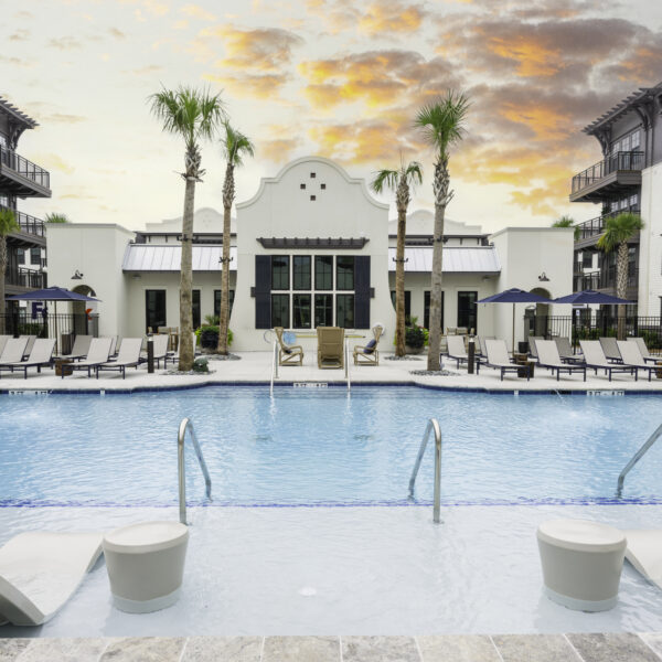 Expansive pool deck with palm trees