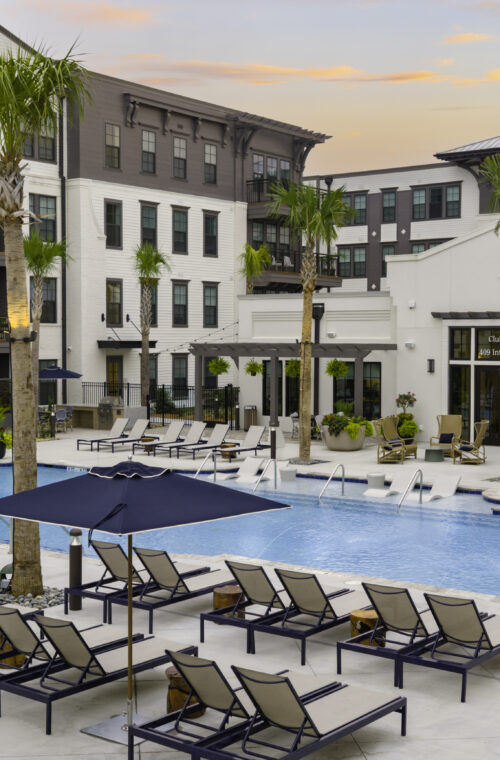Resort-style pool deck with palm trees