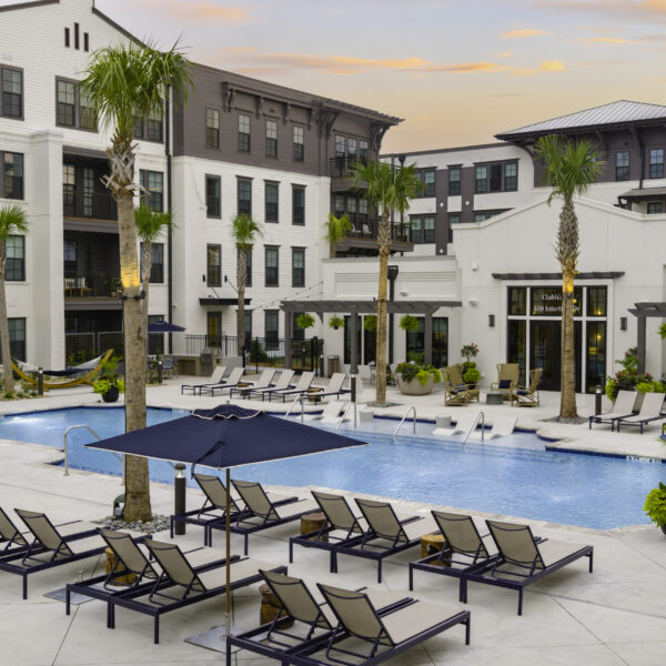 Resort-style pool deck with palm trees