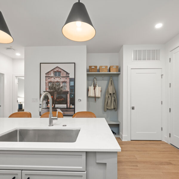 Open-concept kitchen featuring quartz countertops, and built in shelving