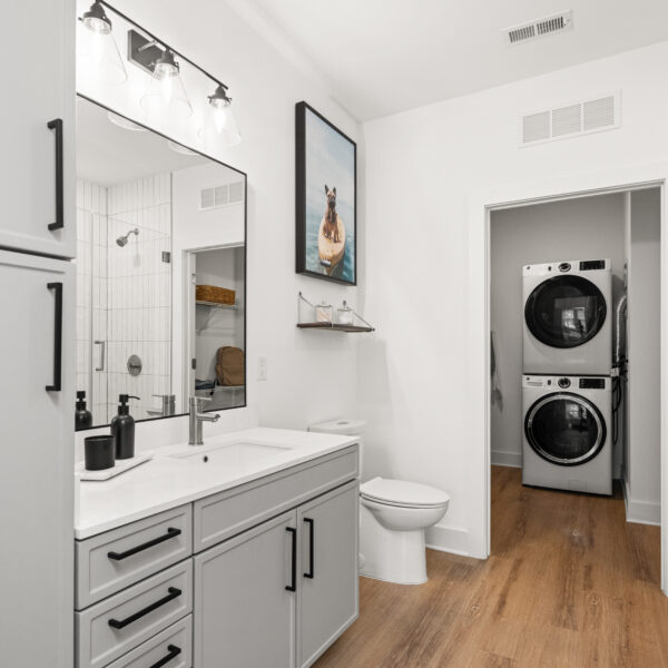 Spacious bathroom with a glass shower, large vanity, double cabinets, and modern lighting.