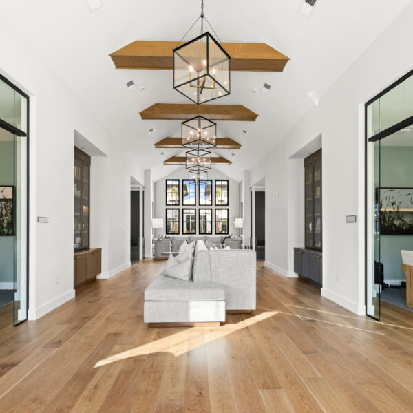 Bright common area featuring expansive windows, wood flooring, and multiple seating areas