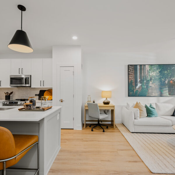 Open living area showcasing a neutral color palette, workspace desk